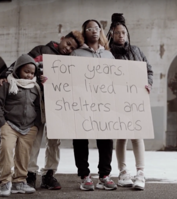 family holding sign